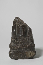 Lower part of a statue of a sitting man with inscription