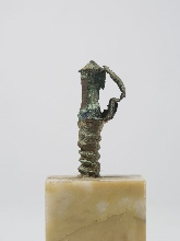 Pommel of a sword with part of the blade (?)