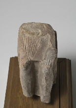 Fragment of a statue of a sitting man with inscription