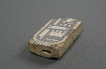 Fragment de cartouche ayant servi d'incrustation