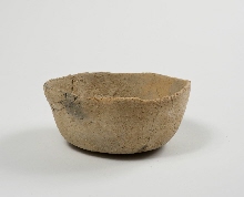 Undecorated dish of red pottery