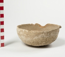 Undecorated dish of red pottery