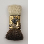 Powder brush with black and white bristle, gilded ring with swallows