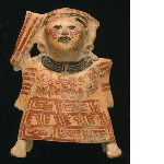 Buzzer-figurine depicting a woman wearing a tunic