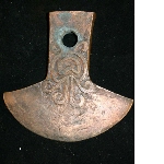 Axe decorated with curls in relief