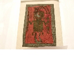 Textile fragment depicting a figure with weapons and trophee-head