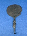 Mirror with handle in the shape of a figurine