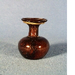 Small vase in dark coloured glass