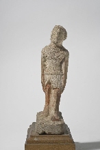 Statue of a walking man, with inscription