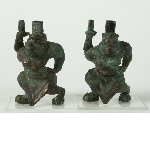 Two supports shaped like kneeling figures